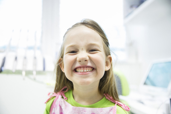 Little girl with big smile in dental chair