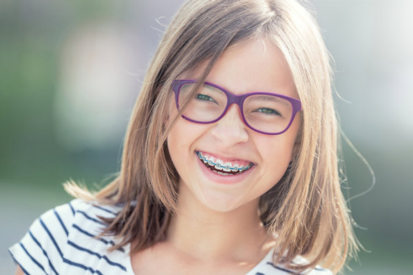 Young girl with braces smiling